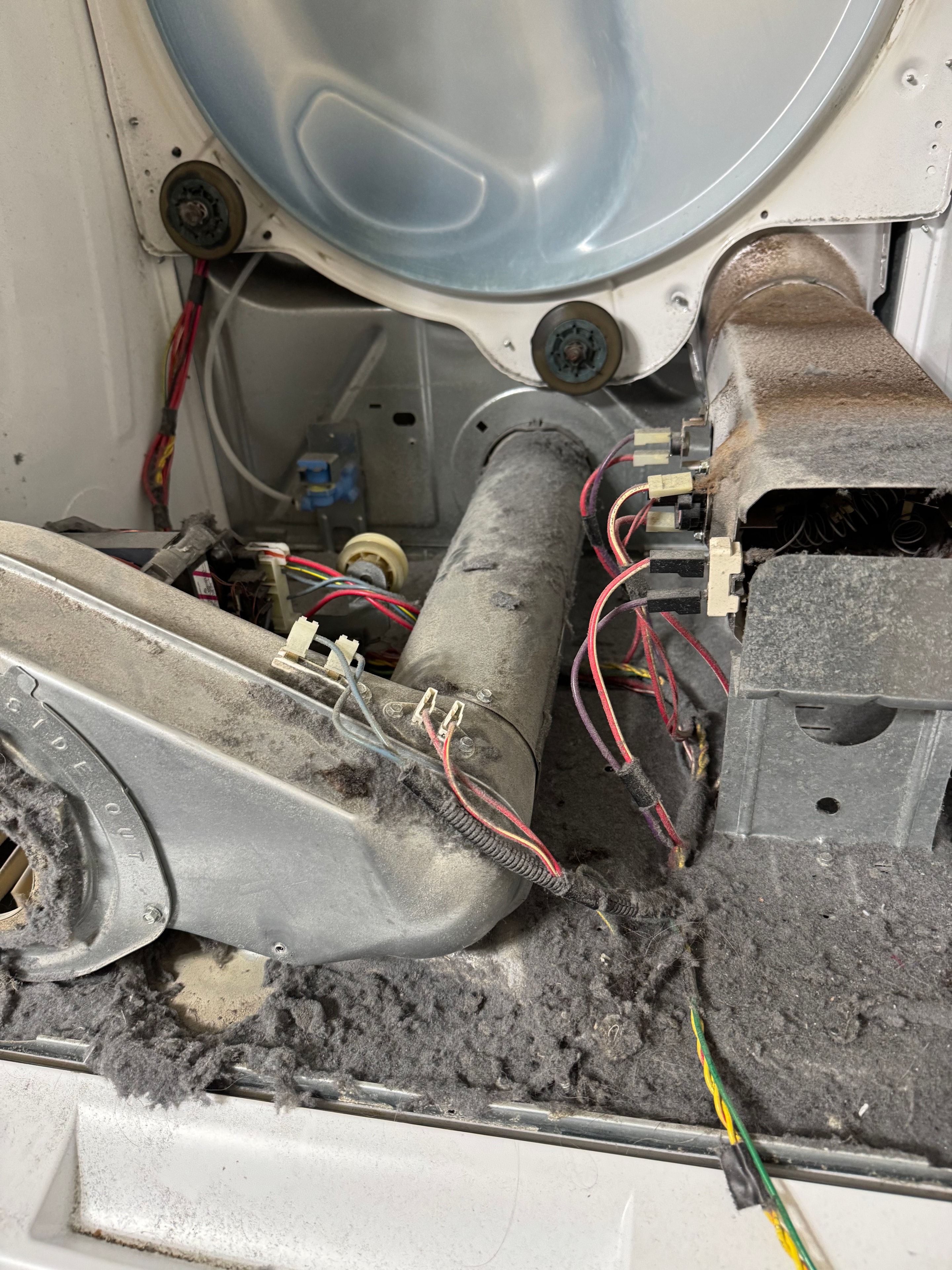Dryer interior clogged with heavy lint buildup — a fire and efficiency hazard
